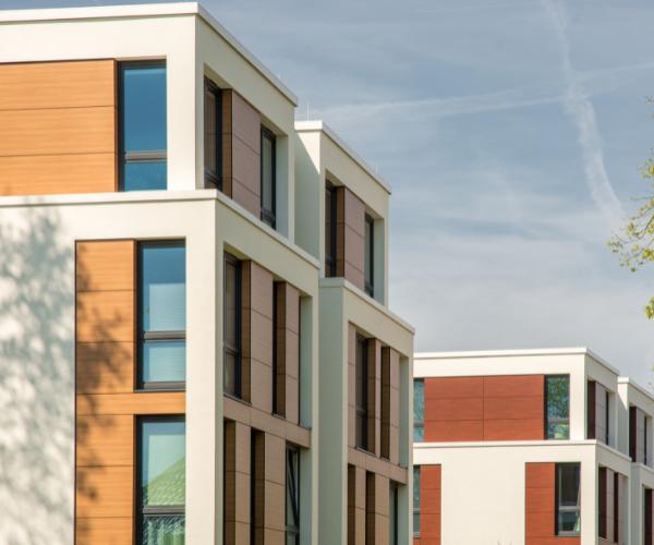 Modern commercial office building with multiple stories, large rectangular windows, and a clean, minimalist exterior.